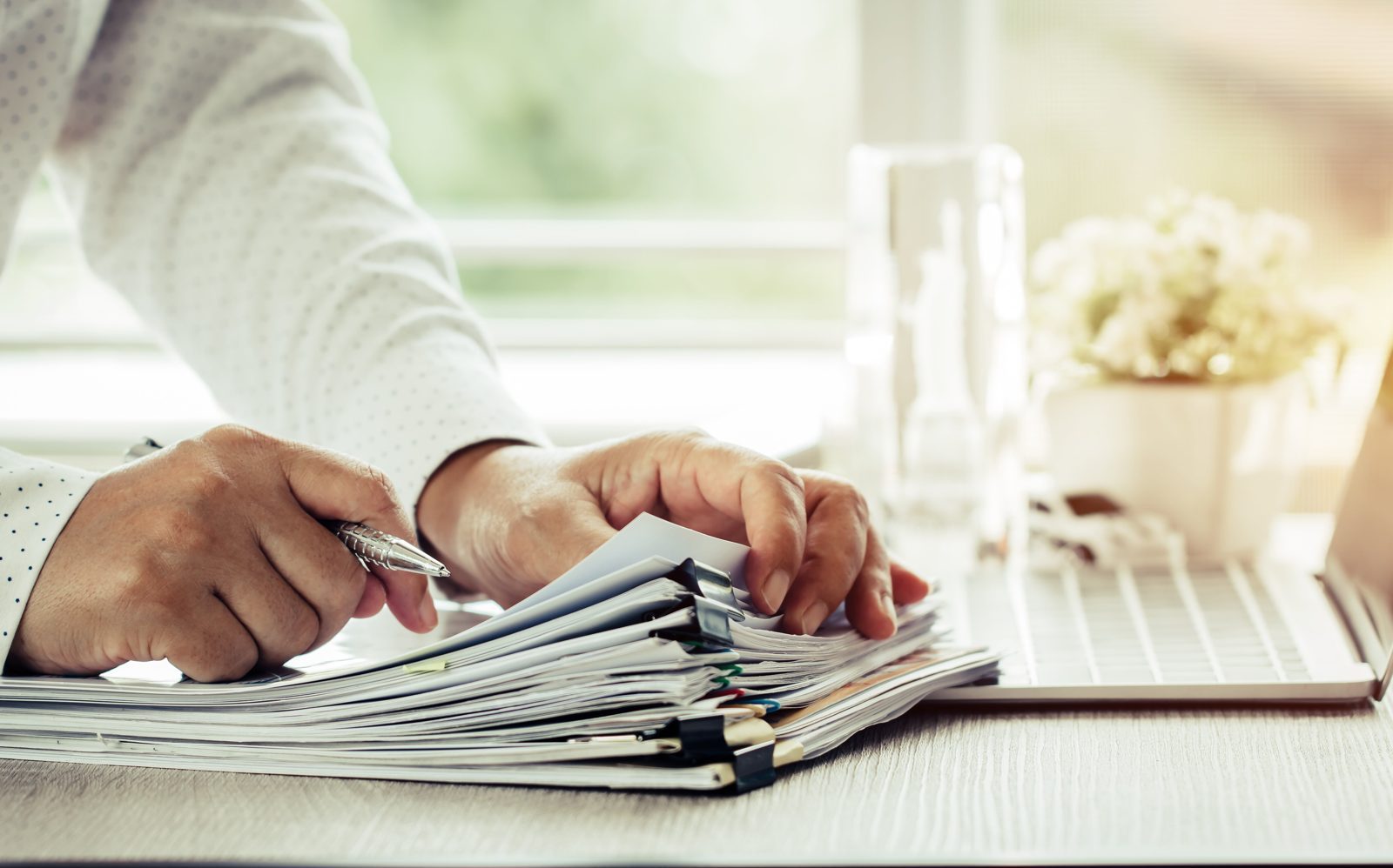 Preparing a personal licence application with a stack of documents
